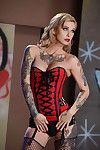 Hot blonde model Kleio Valentien posing solo in red corset and boots